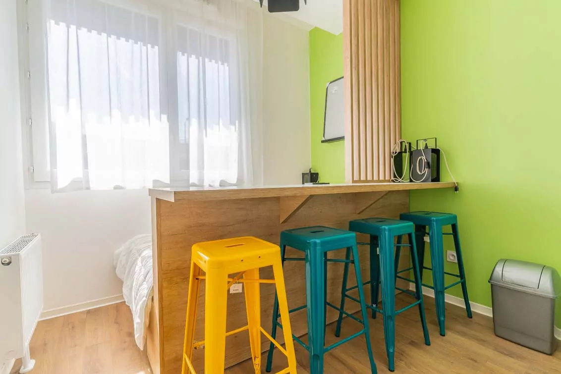 Coin repas avec bar et tabourets d'un logement de la résidence Le Lab à Loos